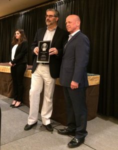 Shown is Schonzeit (on left) accepting the SAMMY Award at ISC West in Las Vegas.