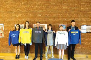 Shown (from left) are: Jennifer Goldberg, Samantha Vulin, Colin Rosa, John Koebel, Aimee Mullins and Jacob Spychalsky holding sweatshirts from the colleges they plan to attend in the fall.