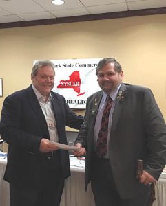 Ed Gallacher, CCIM, (left) presenting a check to John Zygmunt, board member, Central New York Veteran’s Outreach Center.