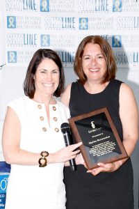 Shown (from left) are: Smile Train CEO Susannah Schaefer presenting a congratulatory plaque to Eva Hatzaki, Skyline Restoration director of marketing. Photo credit: George Constantinou Photography.