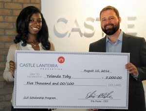 Yolanda Toby, $5,000 award recipient, being congratulated by Elie Rieder, Founder and CEO of Castle Lanterra Properties.