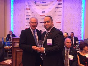 Shown is Miller receiving the Excellence in Real Estate Award on October 19th from Michael Nussbaum, Publisher, Queens Tribune.