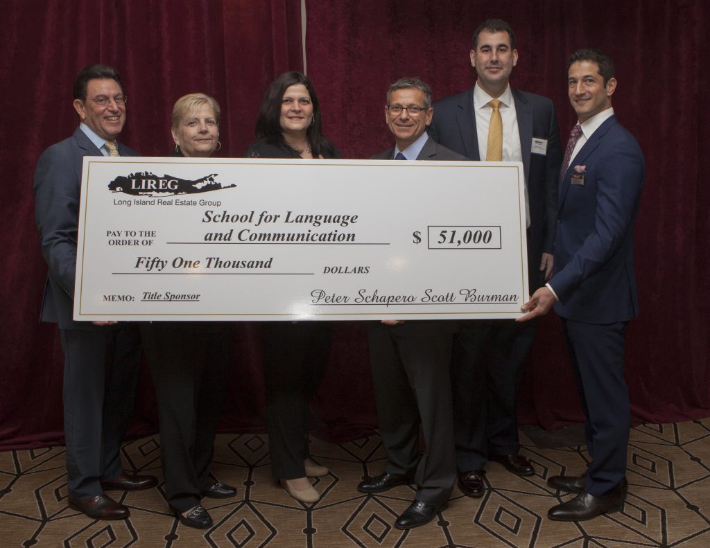 Shown (from left) are: Richard Herzbach, LIREG charity committee chair;  Karen Katzman, principal of the school, Marnie Katzman, director of special events  for the school; Peter Schapero, co-president of LIREG; Matthew Zangwill,  SLCD board member and Scott Burman, co-president of LIREG.