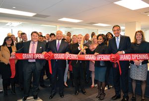  New York State comptroller Thomas DiNapoli, center, cuts the ribbon on SCSCO’s new office space. He is joined by the firm’s equity partners, shown (from left) Sean Duffy, former New York City comptroller William Thompson, CEO and majority owner Suzanne Shank and former HUD secretary Henry Cisneros.